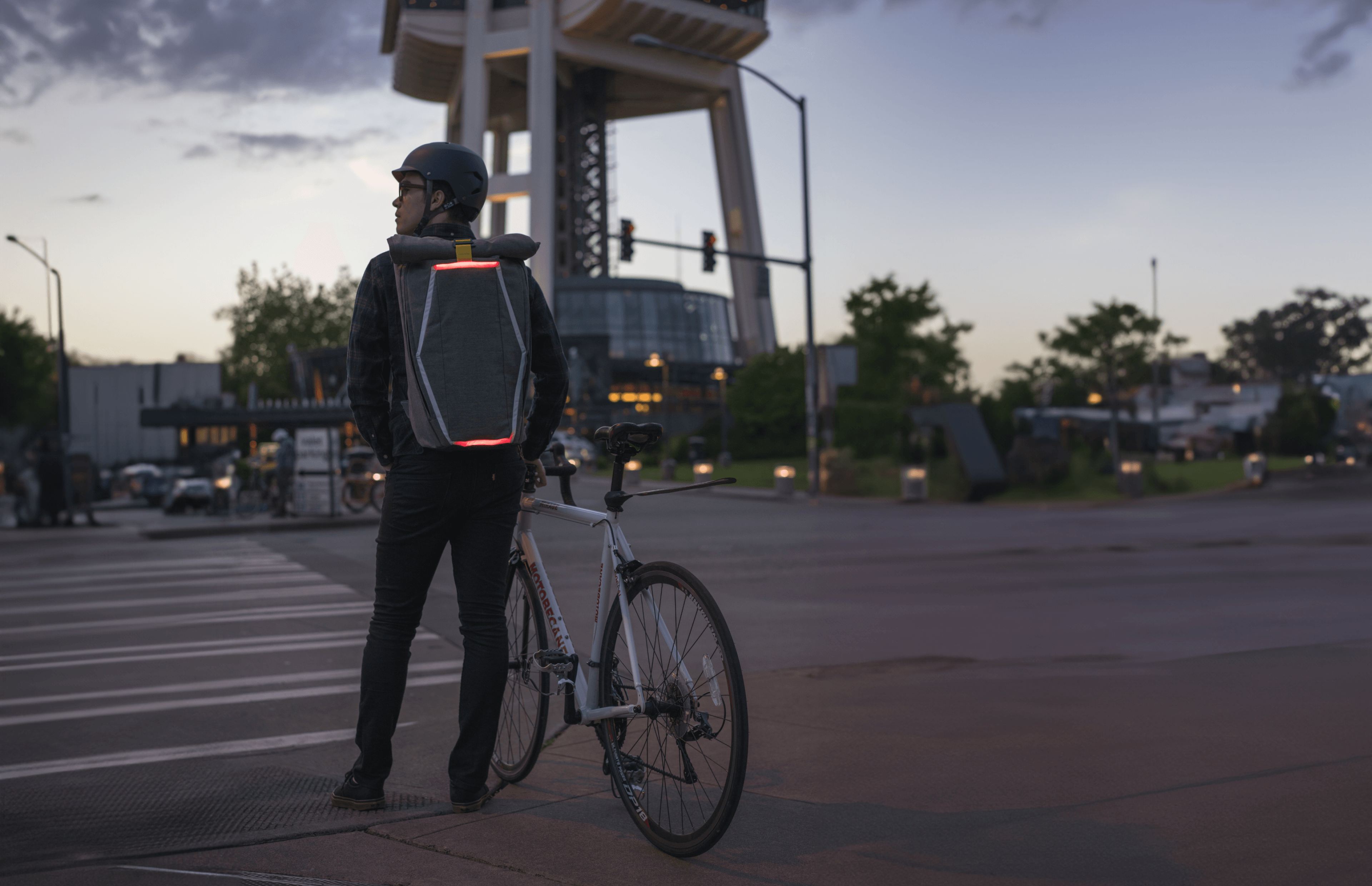 image of a rider wearing the illuminated brake pack prototype at an intersection in front of the space needle